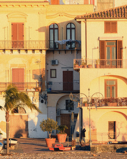 A seaside village square at golden hour