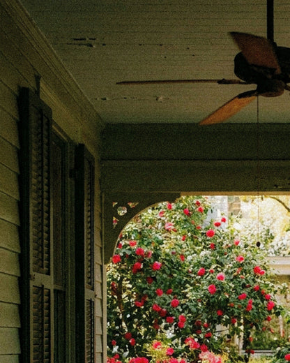 A shaded porch, ceiling fan overhead