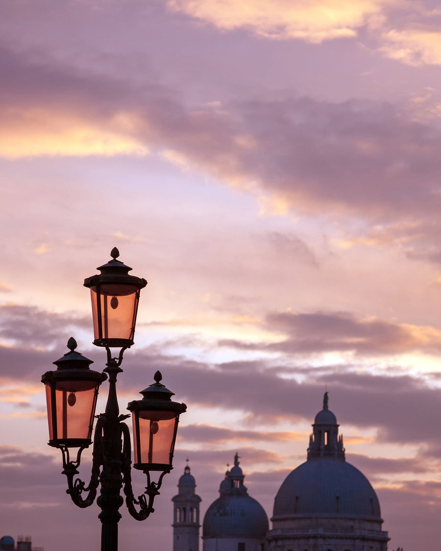 Street lamps against a pink twilight sky