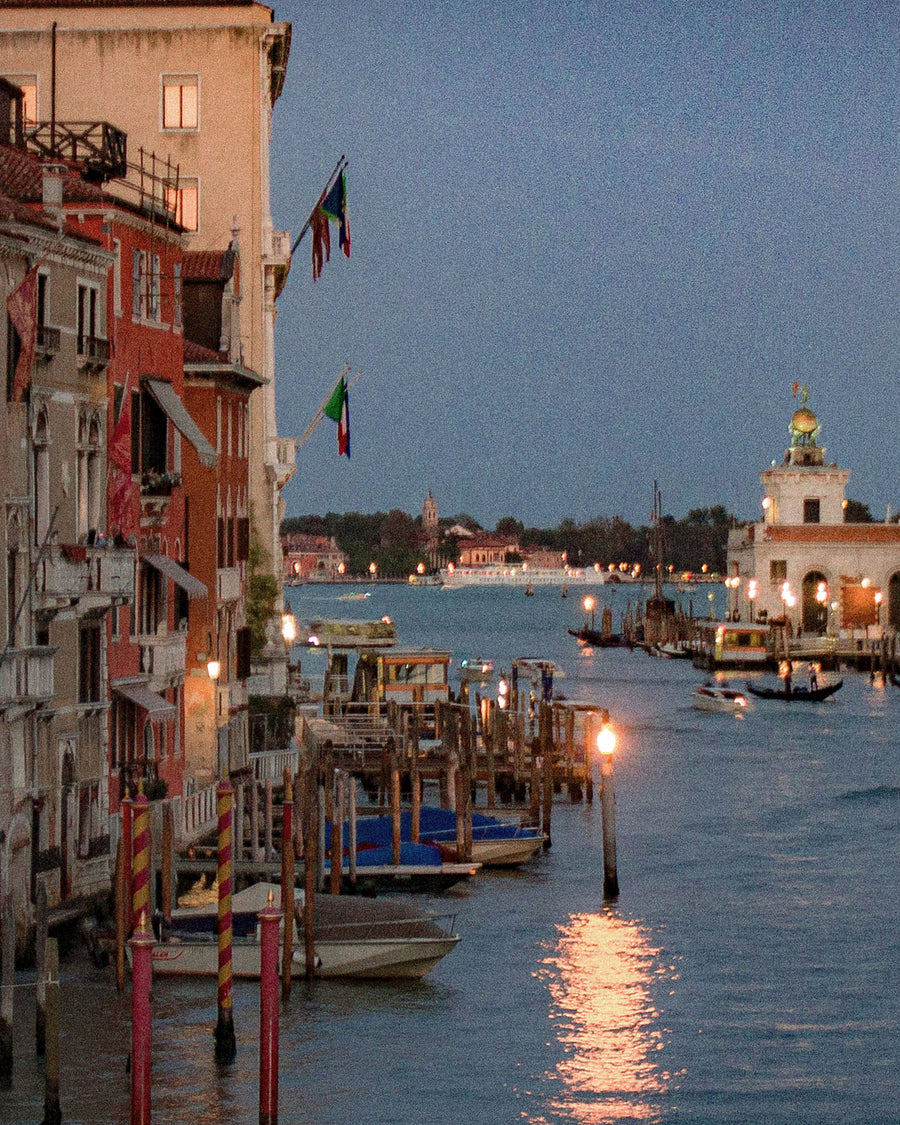 A quiet harbor at dusk, lamps just lit